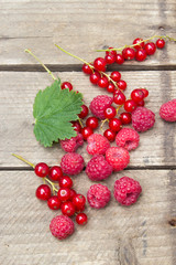 Berries of raspberries and red currants. Summer background. Background in country style.