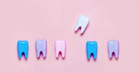 Big teeth on blue and pink background. Minimal concept of teeth health care