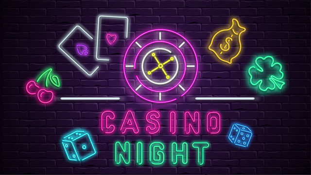 Colorful neon luminous casino night signboard on bricklaying wall.