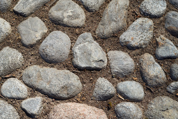 Stones of medieval road close up. Texture.