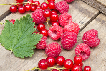 Red berries on an old board. Summer background.