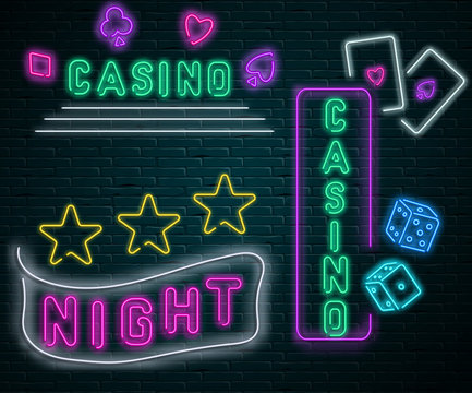 Neon luminous night casino signs on grey bricklaying wall.