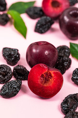 Dried Plums Pitted Prunes and Fresh Plums Background. Selective focus.