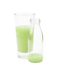 Tall glass of green juice isolated