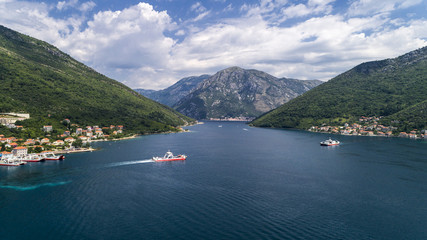 Aerial beautiful view from above to Kotor Bay and regular passenger ferry from Lepetane to Kamenari...
