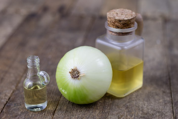 Onion juice and vegetables on a wooden table. Home-made syrup for the treatment of influenza.