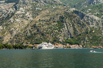 Aerial beautiful View of Kotor bay. Cruise ship docked in beautiful summer day. Ruins of the fortress of St John over Kotor, Montenegro