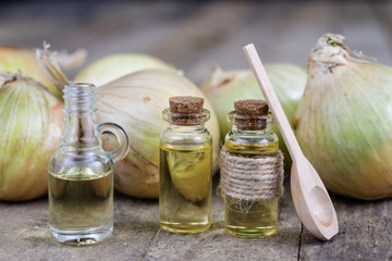 Onion juice and vegetables on a wooden table. Home-made syrup for the treatment of influenza.
