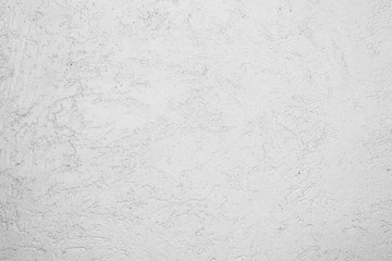 texture of the surface of the wall covered with decorative plaster of the woodworm type
