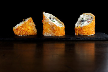 Rolls with chicken and prunes. In breaded.