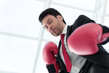 close up.a serious businessman in red Boxing gloves