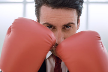 close up.businessman in Boxing gloves holding a punch