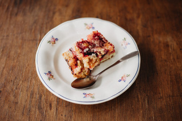 Tasty organic seasonal cake made out of redcurrant, blackcurrant and plum fruit with streusel topping