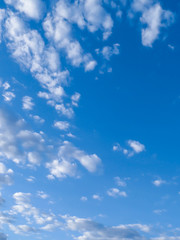 Naklejka na ściany i meble Blue sky with many white clouds during the day. Portrait