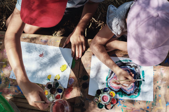 Kids painting art outdoor activity, montessori homeschooling education