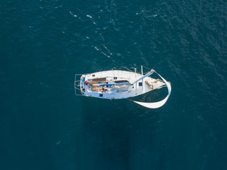 aerial photo of sailboat yacht top view, isolated on the sea texture. participant of sea regatta