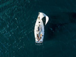 aerial photo of sailboat yacht top view, isolated on the sea texture. participant of sea regatta