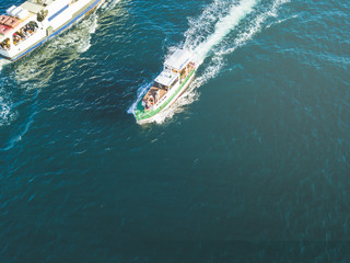 aerial of peple relax and sun tanning in the fast motor boat top view in the summer sea