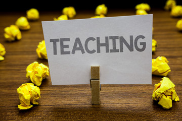 Fototapeta premium Word writing text Teaching. Business concept for Act of giving information, explaining one subject to a person Clothespin hold holding paper idea reminder crumpled papers several tries.