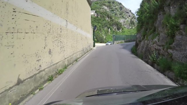 Footage taken from car roof of Italian roads located at Amalfi Coast Italy driving over the narrow one way street corners later showing typical italian scooter warp stabilized view 4k high resolution