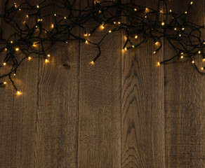 Christmas Light or Garland Lights on Wood Background