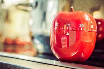 15 Minutes - Red Kitchen Egg Timer On Cooktop Next To A Pot