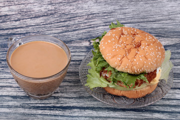 Ready served of a cup of coffee and deep-fried dough stick.