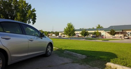 Drone Dolly Shot Past Silver 4-Door Car