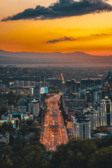 Naklejka premium Sunset over the city of Almaty and a view of the Kok Tobe TV Tower