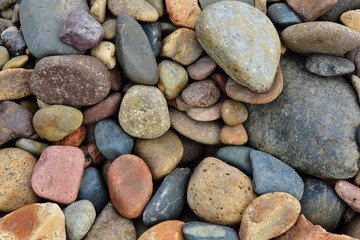 Fototapeta na wymiar Stones of different shapes and sizes. Gravel, cobblestones form a background. Material for construction