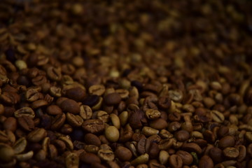 Coffee beans texture. An invigorating background for coffee lovers with blur copy space