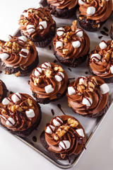 Chocolate cupcakes with nuts and marshmallows