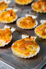 oven baked scallop with cheese, bell pepper and herbs