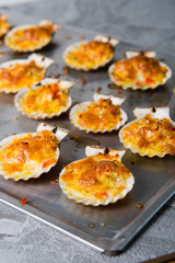 oven baked scallop with cheese, bell pepper and herbs
