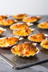 oven baked scallop with cheese, bell pepper and herbs