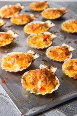 oven baked scallop with cheese, bell pepper and herbs