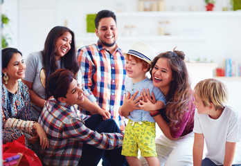 group of cheerful friends having fun together, playing with kids