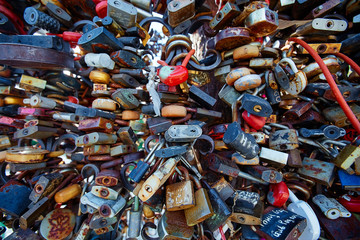 Closed wedding locks on a metal forged fence in the Park. Wedding details, Valentine's day, the concept of a strong and faithful marriage