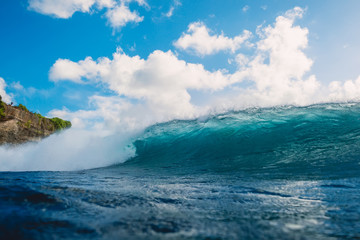 Crashing blue wave in ocean. Breaking barrel wave