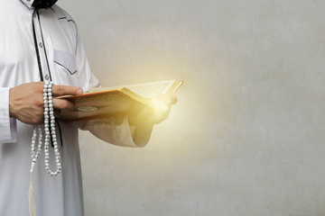 muslim man reading a Quran. There was a light of hope and faith.