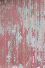 Grungy red metal painted sheet peeling paint