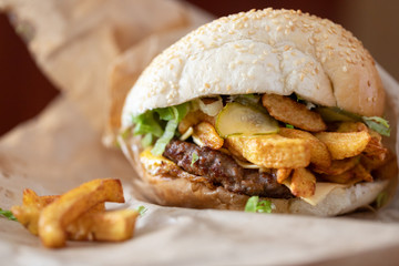 Close up of burger with meat and French fries