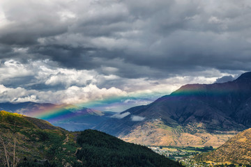Fototapeta premium Rainbow in the mountains of Queenstown, South Island, New Zealand