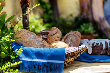 Basket with fresh bread on the table outside the house