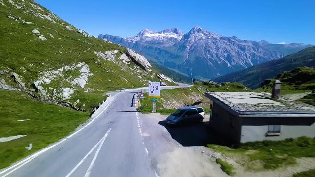 Splugenpass pan out from road sign to valley panorama