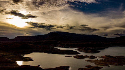 Aerial view of Lake Powell near Navjo Mountain, San Juan River in Glen Canyon with colorful buttes, skies and water