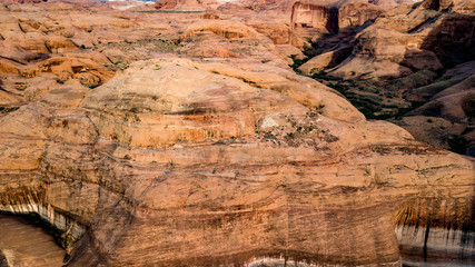 Aerial view of Lake Powell near Navjo Mountain, San Juan River in Glen Canyon with colorful buttes, skies and water