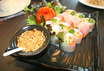 Fresh spring rolls with sweet sauce on wood table background