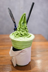 Glass of iced matcha latte with matcha soft cream.