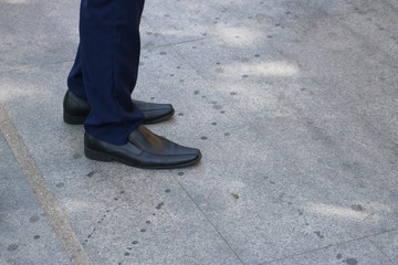 Close up of a man standing on the floor.